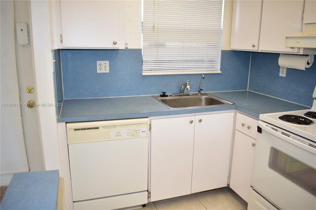 kitchen featuring white appliances, backsplash, sink, white cabinets, and light tile patterned flooring