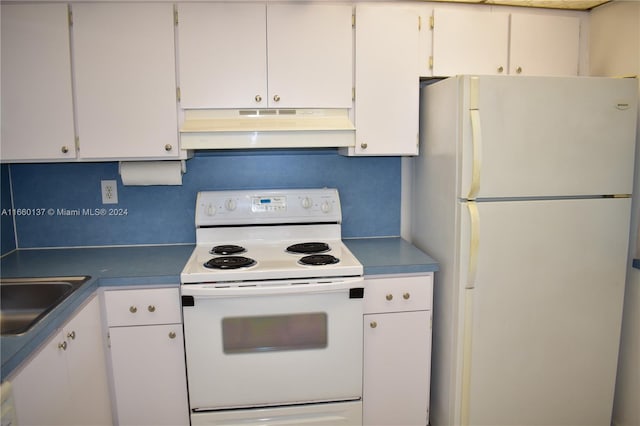 kitchen with sink, white appliances, and white cabinets