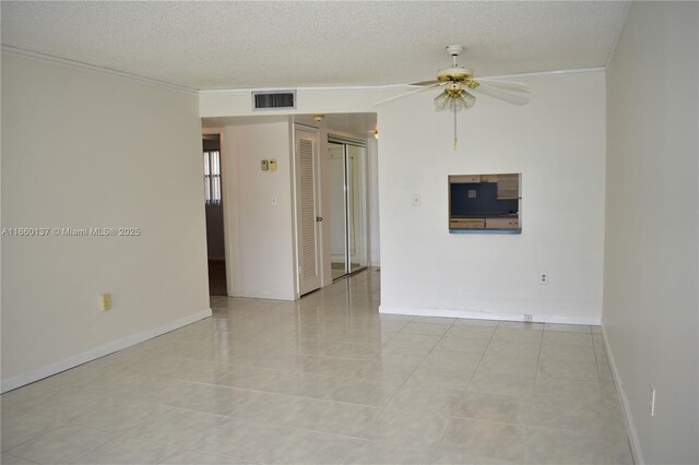 unfurnished room featuring a water view, ceiling fan, light tile patterned floors, and ornamental molding