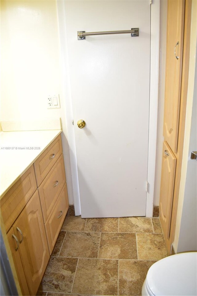 bathroom with a shower with door and vanity