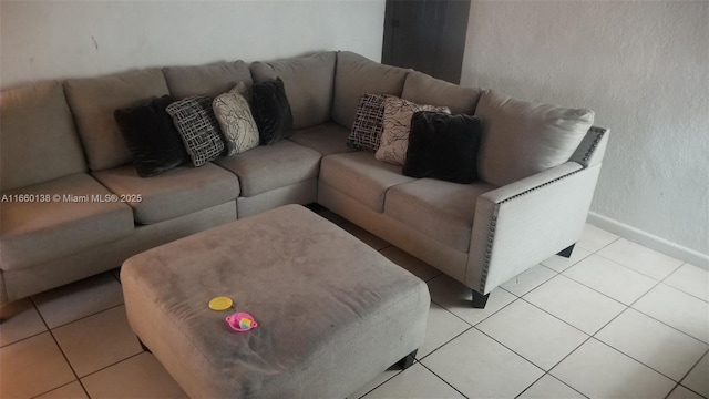 living room with light tile patterned flooring and baseboards