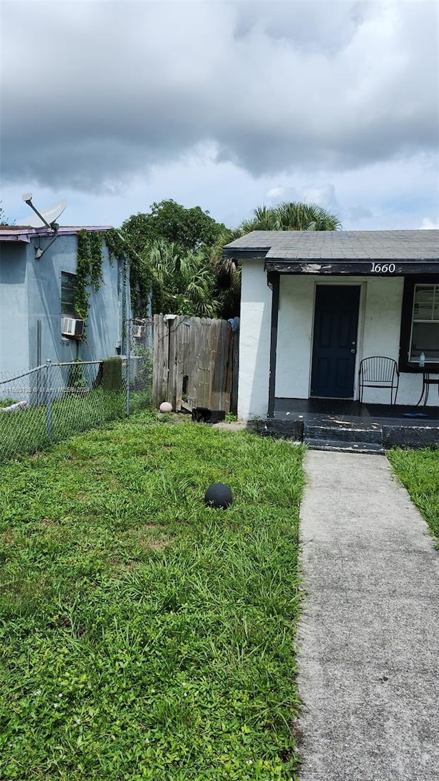 view of yard with cooling unit and a porch