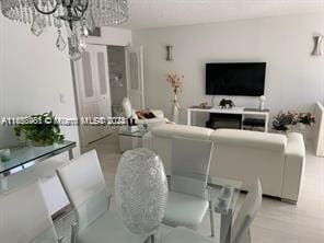 living room featuring light hardwood / wood-style floors and an inviting chandelier