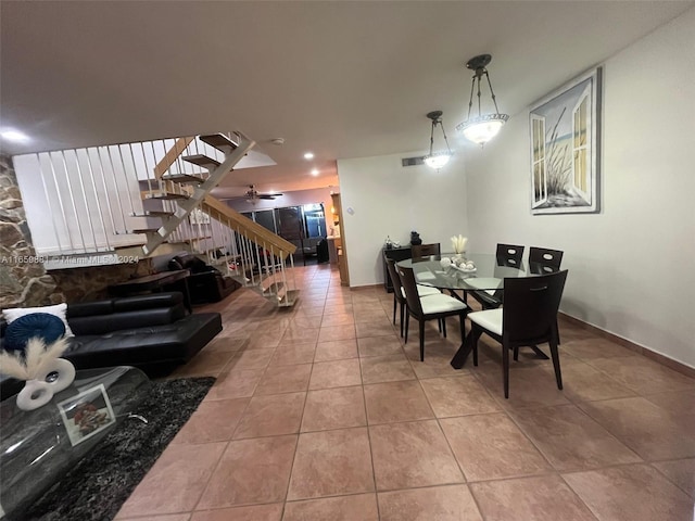 tiled dining room with ceiling fan