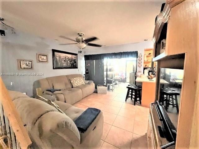 tiled living room with ceiling fan