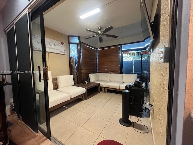 interior space with light tile patterned floors and ceiling fan