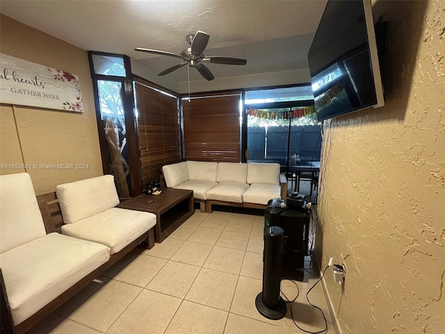 living room featuring light tile patterned flooring and ceiling fan