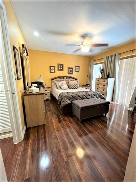 bedroom with ceiling fan and dark hardwood / wood-style floors