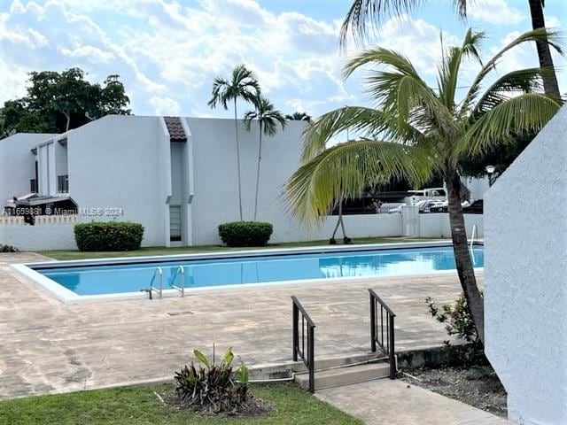 view of swimming pool with a patio