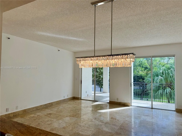 unfurnished dining area with plenty of natural light and a textured ceiling