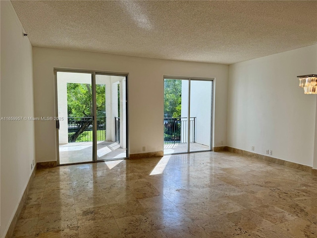 unfurnished room with a textured ceiling