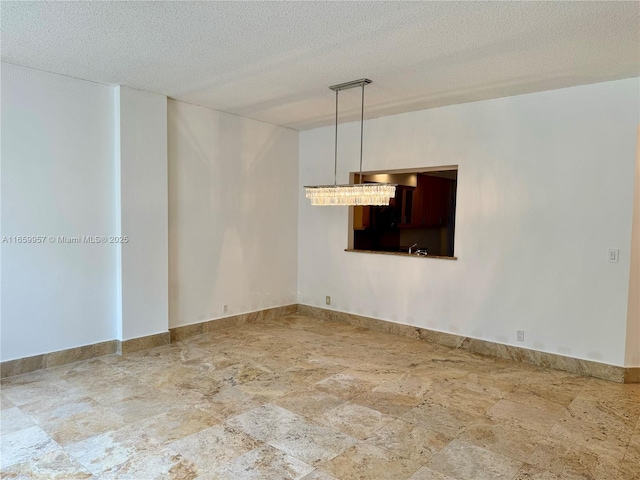 empty room featuring a textured ceiling