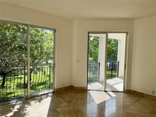 entryway featuring plenty of natural light and a textured ceiling