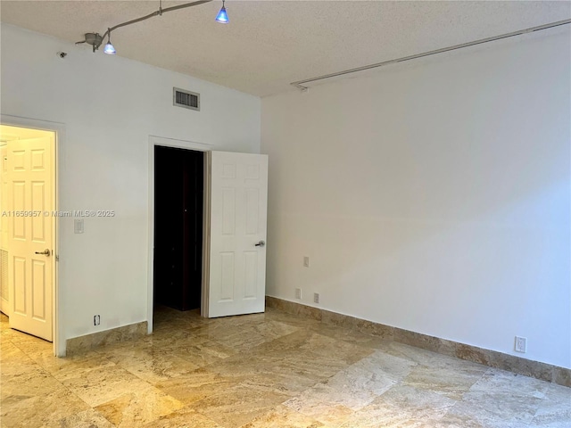 spare room with a textured ceiling