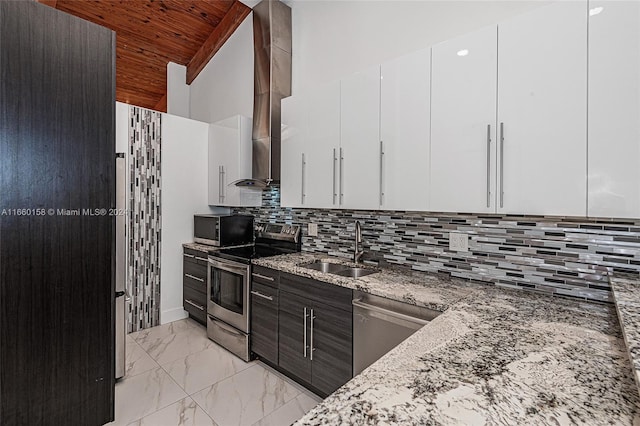 kitchen with appliances with stainless steel finishes, white cabinets, light stone countertops, and sink