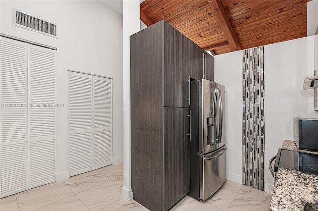 kitchen with stainless steel appliances, dark brown cabinets, lofted ceiling with beams, and wooden ceiling