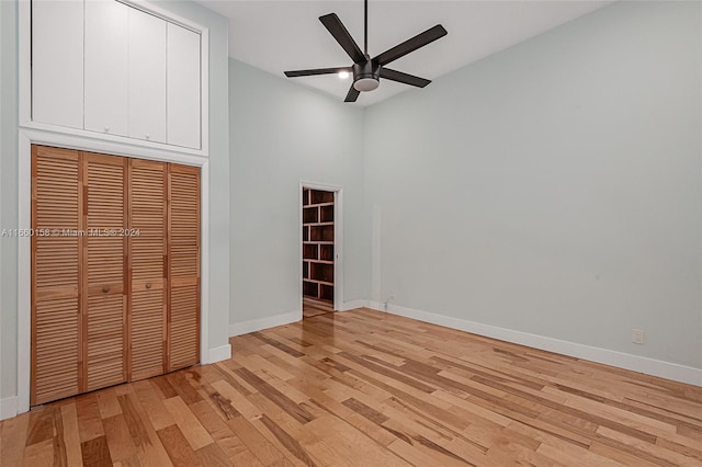 unfurnished bedroom with light wood-type flooring, a closet, and ceiling fan