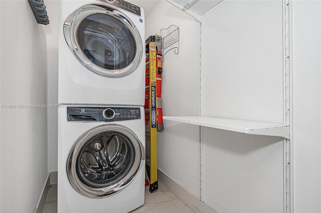 laundry room with stacked washer / drying machine