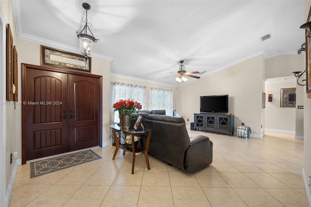 tiled living room featuring lofted ceiling, ceiling fan with notable chandelier, and crown molding