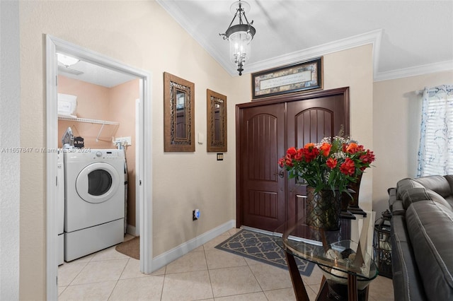 tiled entryway featuring crown molding, an inviting chandelier, and washer / clothes dryer