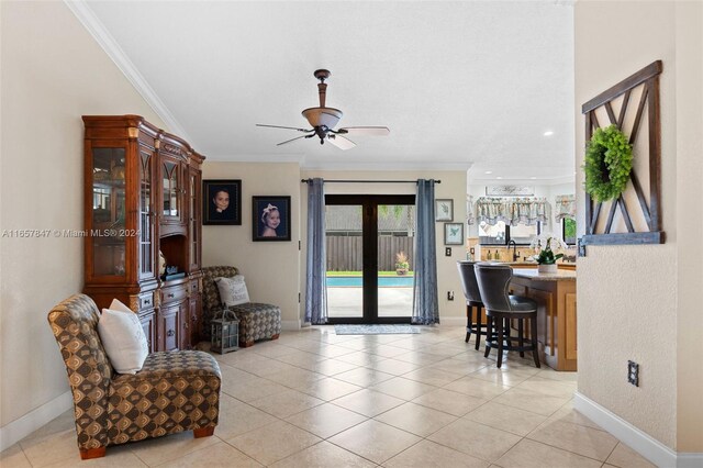 interior space featuring crown molding, french doors, light tile patterned flooring, and ceiling fan