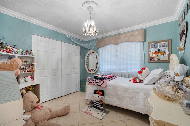 bedroom featuring light tile patterned floors, an inviting chandelier, a closet, ornamental molding, and a textured ceiling