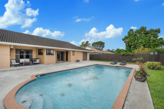 view of pool with an outdoor living space and a patio