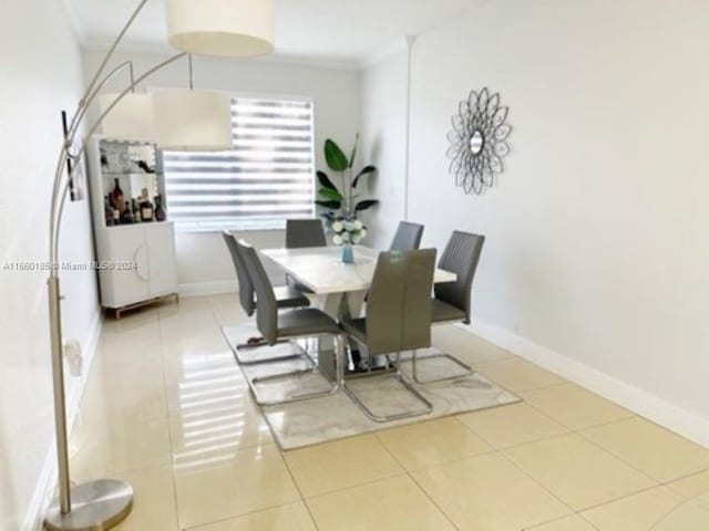 dining space with tile patterned flooring