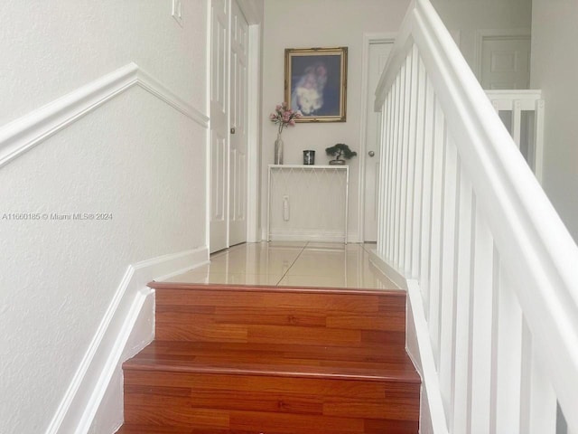 stairs with tile patterned flooring