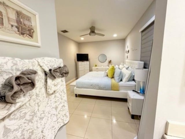 bedroom with ceiling fan and light tile patterned floors