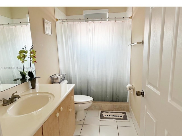 bathroom with vanity, toilet, a shower with shower curtain, and tile patterned floors