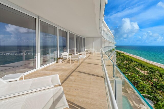 balcony with a view of the beach and a water view