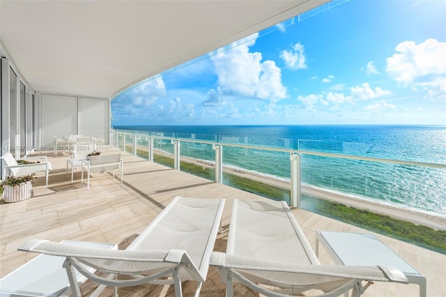 balcony with a view of the beach and a water view