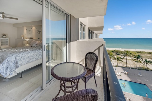 balcony with a water view and a beach view