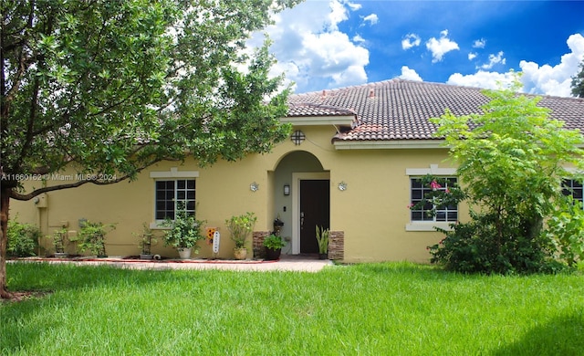 mediterranean / spanish-style home featuring a front lawn