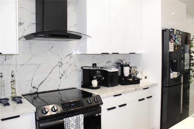 kitchen featuring white cabinets, light stone countertops, black appliances, decorative backsplash, and island range hood