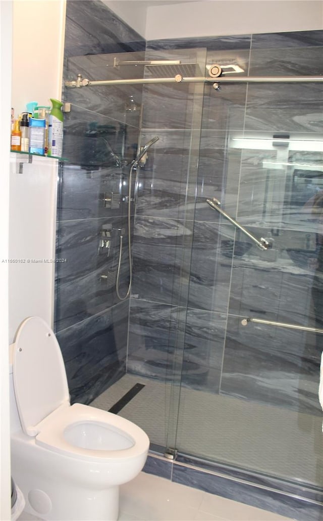 bathroom with walk in shower, toilet, and tile patterned flooring