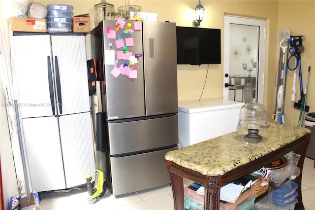 kitchen featuring stainless steel fridge and light tile patterned flooring