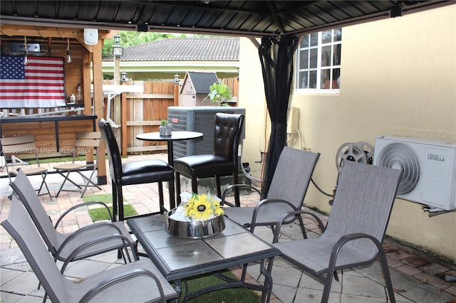 view of patio featuring ac unit and a gazebo