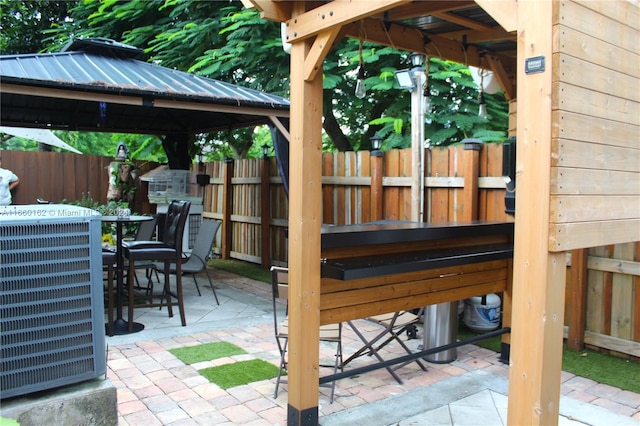 view of patio featuring central air condition unit and a gazebo