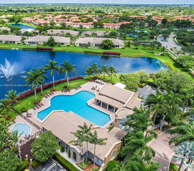 view of swimming pool featuring a water view and a patio area