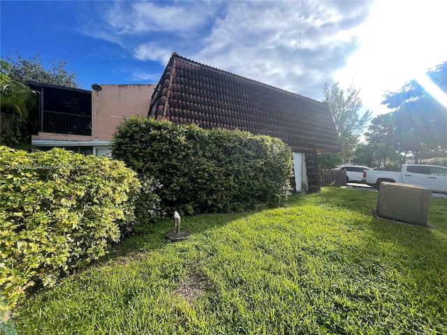 view of side of property with a lawn