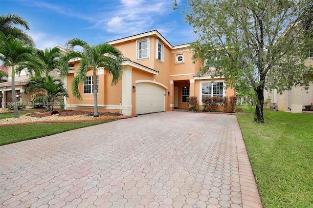 mediterranean / spanish-style house featuring stucco siding, decorative driveway, a front yard, a tile roof, and an attached garage