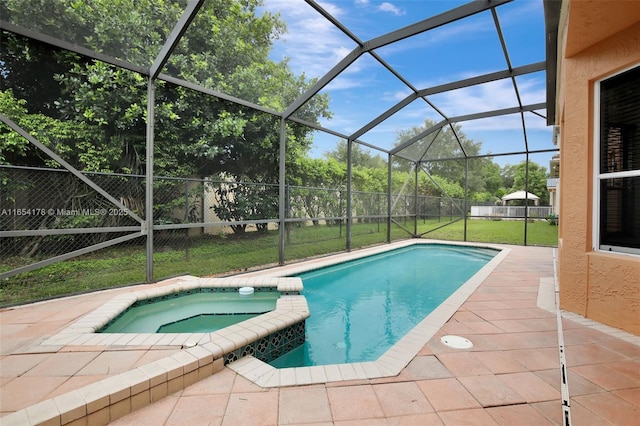 view of swimming pool featuring a pool with connected hot tub, a patio, a lawn, and a lanai