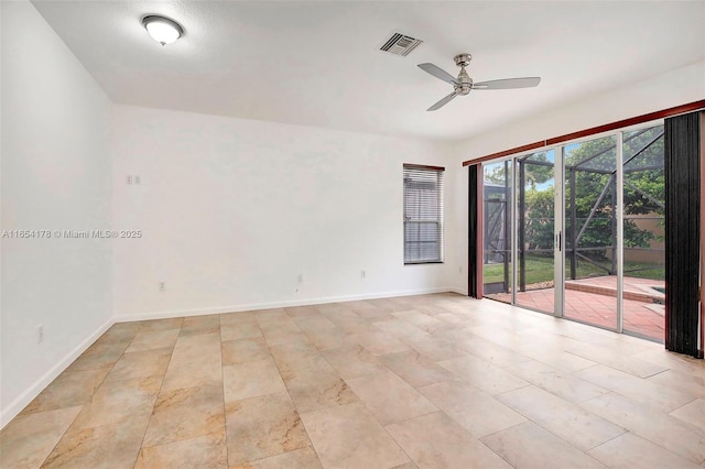 unfurnished room featuring visible vents, baseboards, and a ceiling fan