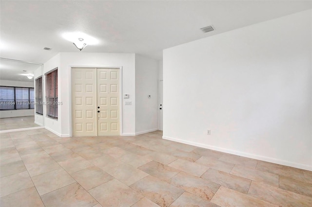 unfurnished bedroom featuring visible vents, baseboards, and light tile patterned flooring