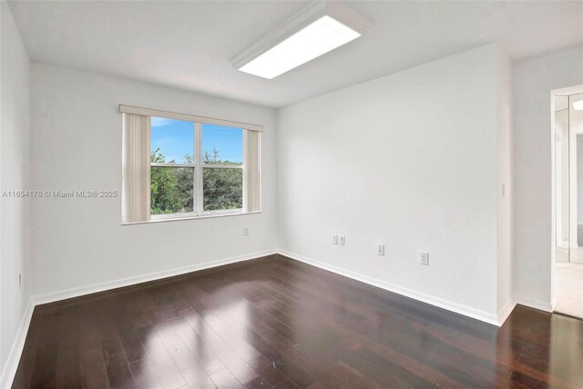 spare room with dark hardwood / wood-style flooring