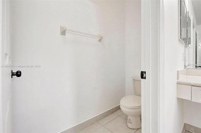 bathroom with tile patterned flooring, vanity, and toilet