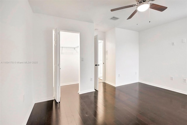 unfurnished room with wood finished floors, ceiling fan, baseboards, and visible vents