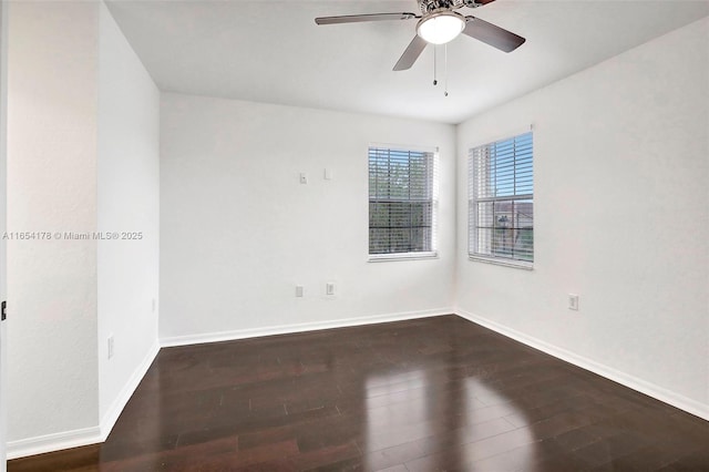 spare room featuring ceiling fan, baseboards, and wood finished floors